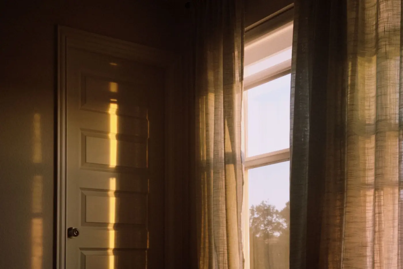 Golden morning light streaming into a quiet room